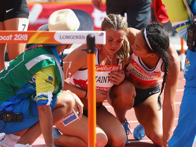 GOLD COAST, AUSTRALIA - APRIL 12:  Katie Stainton of England is assisted by Katarina Johnson-Thompson of England as she falls in the Women's Heptathlon 100 metres hurdles heats during athletics on day eight of the Gold Coast 2018 Commonwealth Games at Carrara Stadium on April 12, 2018 on the Gold Coast, Australia.  (Photo by Michael Steele/Getty Images)