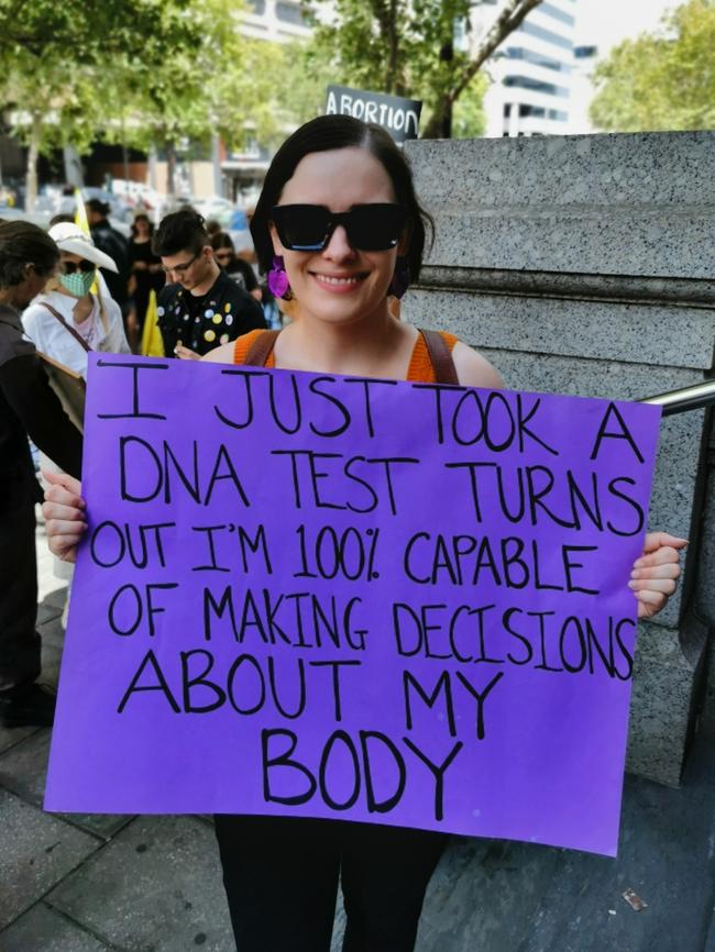 Emily Gore holds a sign at the rally.