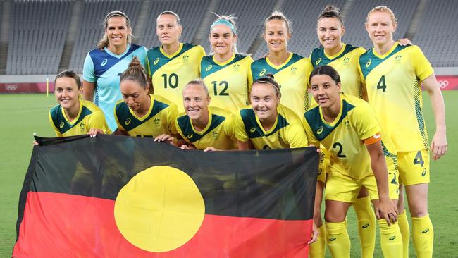 The Matildas posed for their pre-game picture with the Aboriginal flag proudly on display. Picture: AFP