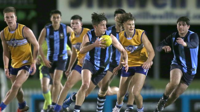 Immanuel’s Riley Talbot escapes from the pack in the college football round three clash against Sacred Heart. Picture: Dean Martin