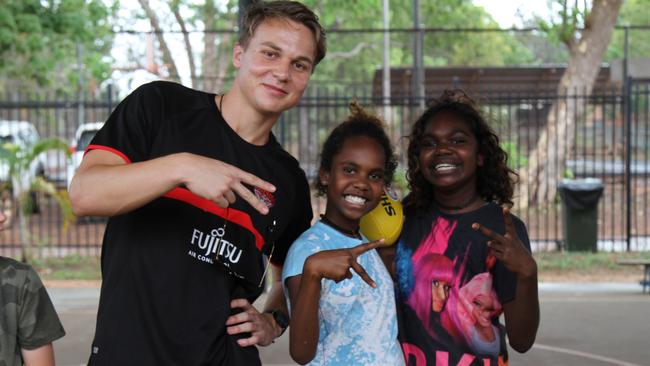 Dylan Clarke with students at Maningrida as part of the club’s “Right of Passage” camp. Picture: NATALIE MacGREGOR