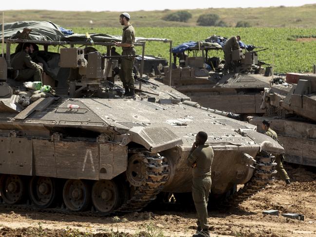 ISRAEL - APRIL10: Israeli soldiers  prepare their equipment and armored personnel carriers before entering into the Gaza Strip on April 10, 2024 in Southern Israel. April 7th marks six months since Hamas led an attack on Israel, killing 1,200 people and taking around 250 people hostage. In response, Israel launched a retaliatory war in Gaza that has killed more than 33,000 people, according to the Gazan health ministry. As the latest round of ceasefire negotiations have stalled, the humanitarian crisis worsens in Gaza, while more than 100 Israeli hostages remain in captivity.(Photo by Amir Levy/Getty Images)