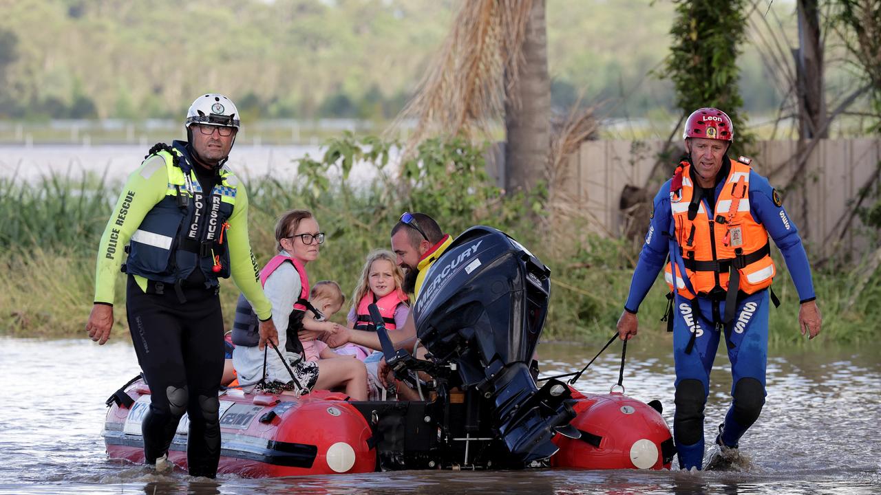 Kyle Eggins, wife Ellymae and their kids Selena 7 (pink jacket), Cooper 10 (green jacket), Brock 5 (blue jacket) and baby Emmy-Jane needed to be evacuated from their Gulmarrad property after the South Arm river inundated their property. Picture: Toby Zerna