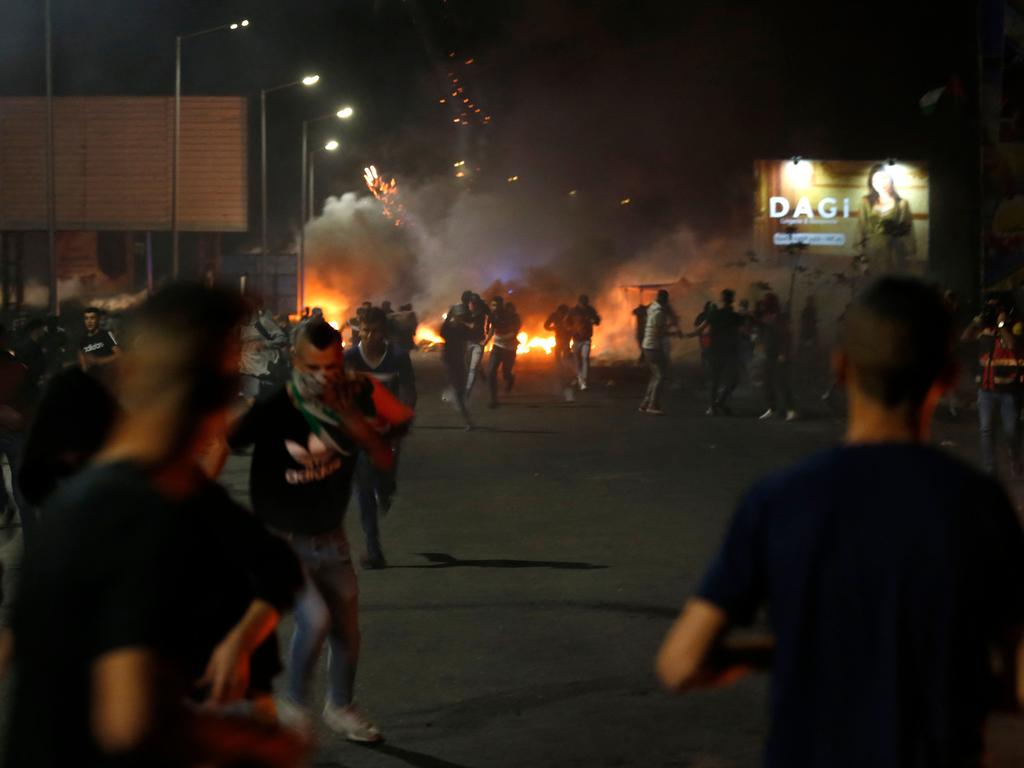 Palestinians run away from gas fired by Israeli soldiers during an anti-Israel demonstration. Picture: Abbas Momani/AFP