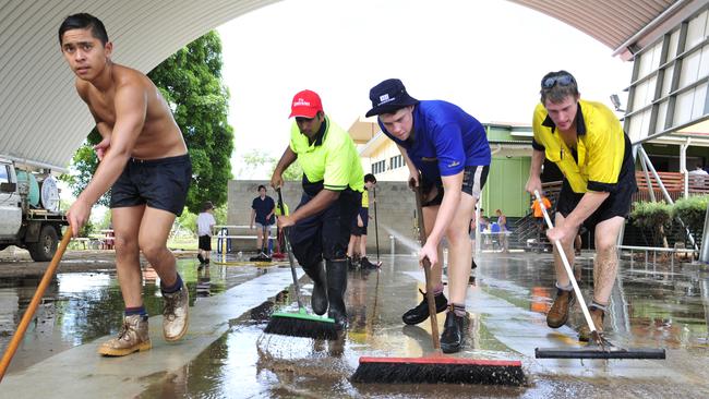 Students from St Marys school in Toowoomba help out with the clean-up at St Marys school in Laidley on Friday. Photo: Rob Williams / The Queensland Times