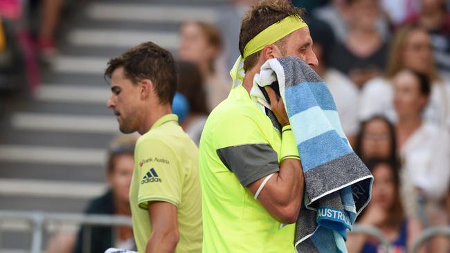 Tennys Sandgren of the US  walks past Dominic Thiem during their men's singles match. Picture: AFP