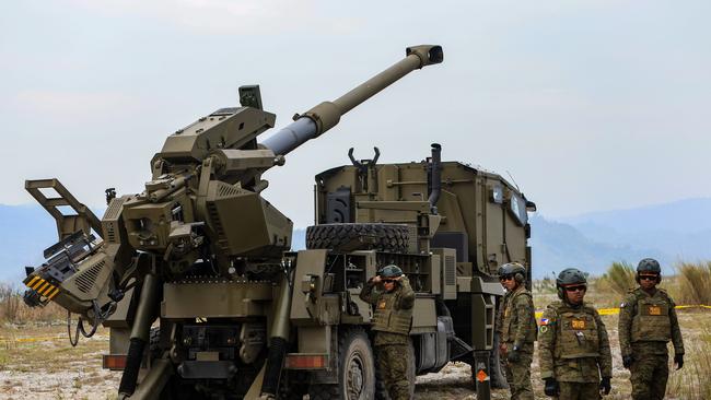 Filipino soldiers prepare for shelling as a self-propelled artillery vehicle is deployed during a combined field artillery live fire exercise as part of the US-The Philippines Balikatan military exercises, amid growing threats from China, near New Clark City, The Philippines, 14 April 2023.