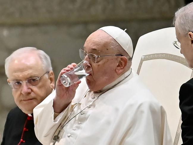 Pope Francis drinks a glass of water to help him give his speech during his weekly general audience on February 12. Picture: AFP