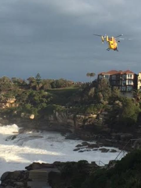 The Westpac helicopter scours the ocean south of Bondi’s Icebergs club, where a man is missing.