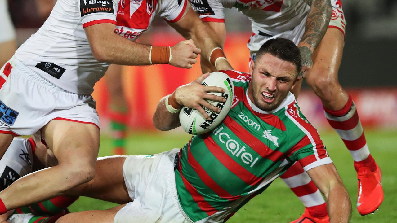 Rabbitohs Sam Burgess is downed by the Dragons defence