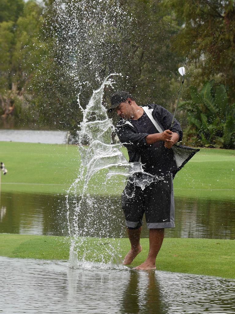 The extra water hazards did not deter Richard Mamando from practising his swing at Emerald Lakes. Picture: Steven Holland