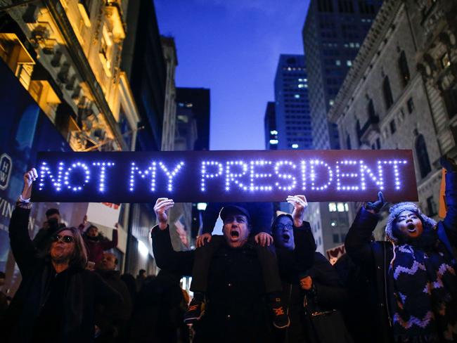 Demonstrators protest against US President-elect Donald Trump in front of Trump Tower on November 12, 2016 in New York. Americans spilled into the streets Saturday for a new day of protests against Donald Trump, even as the president-elect appeared to back away from the fiery rhetoric that propelled him to the White House. Picture: AFP PHOTO / KENA BETANCUR