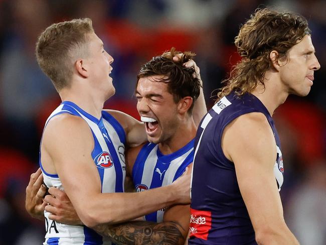 MELBOURNE, AUSTRALIA - MARCH 23: Tom Powell of the Kangaroos (L) celebrates a goal with teammate Jy Simpkin during the 2024 AFL Round 2 match between the North Melbourne Kangaroos and the Fremantle Dockers on March 23, 2024 in Melbourne, Australia. (Photo by Dylan Burns/AFL Photos via Getty Images)