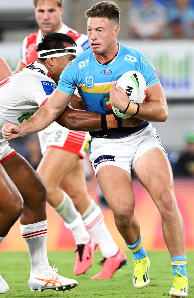 GOLD COAST, AUSTRALIA - MARCH 09: Sam Verrills of the Titans is tackled during the round one NRL match between Gold Coast Titans and St George Illawarra Dragons at Cbus Super Stadium, on March 09, 2024, in Gold Coast, Australia. (Photo by Bradley Kanaris/Getty Images)