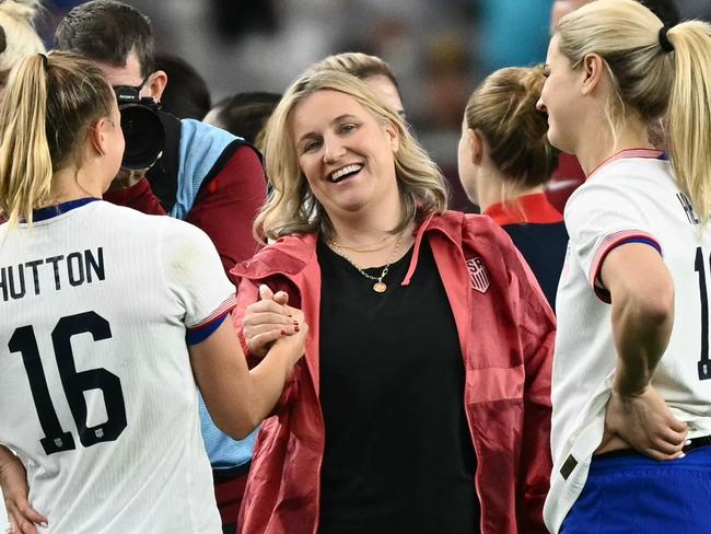 USA coach Emma Hayes (centre) celebrates with players Claire Hutton (left) and Lindsey Heaps after beating Australia 2-1. Picture: Patrick T. Fallon / AFP