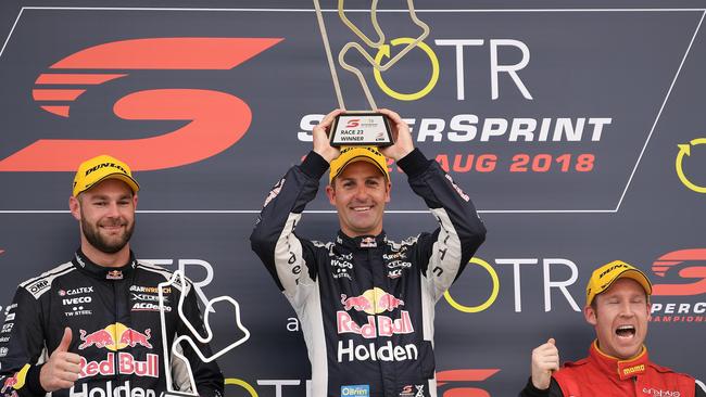 Race Two runner-up and new championship leader Shane van Gisbergen, Red Bull Holden Racing Team teammate and Race Two winner Jamie Whincup and third-place getter David Reynolds on the podium at The Bend. Picture: Daniel Kalisz/Getty Images