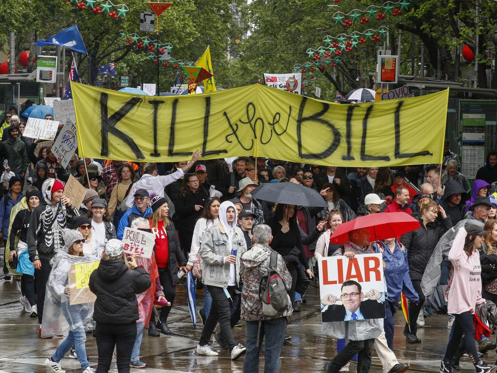 Protesters held up signs as they chanted ‘lockdowns kill’. Picture: NCA NewsWire/Daniel Pockett