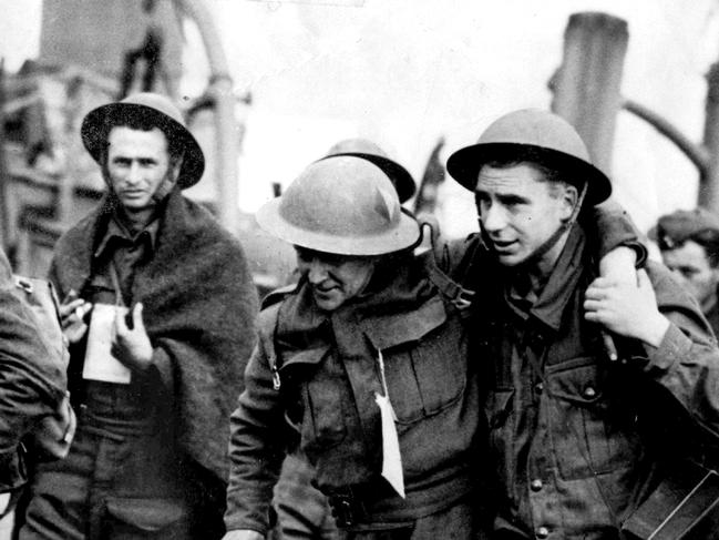 Evacuation of Dunkirk France May 1940. BEF men were rescued on a variety of vessels - helping a wounded man ashore at Dover. WWII British Armed Forces history