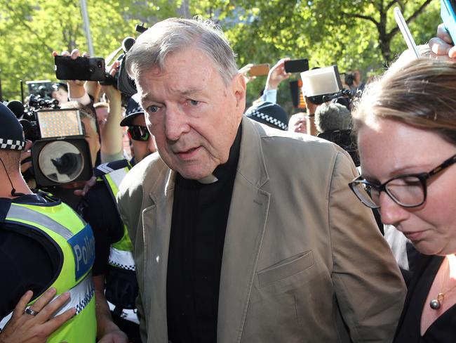 TOPSHOT - Cardinal George Pell (C) makes his way to the court in Melbourne on February 27, 2019. - Cardinal George Pell arrived in court, possibly for the last time as a free man, in a last-ditch push to apply for bail after his historic conviction for child sex crimes. (Photo by Con CHRONIS / AFP)