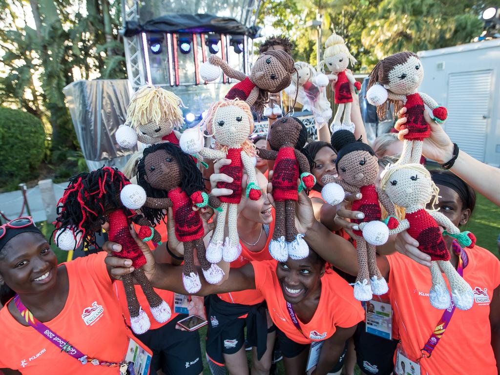 The England Roses netball team pose with their crocheted “lookalikes”.