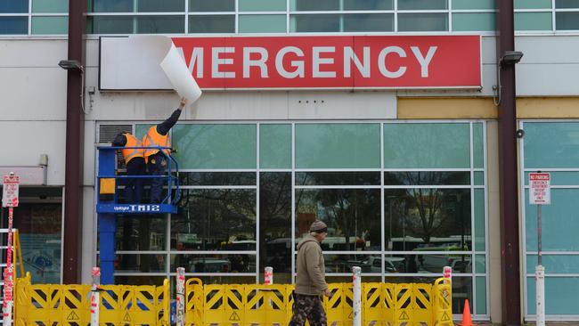 Work begins to remove signage from the old RAH, which has now closed. Picture: AAP Image/Brenton Edwards.