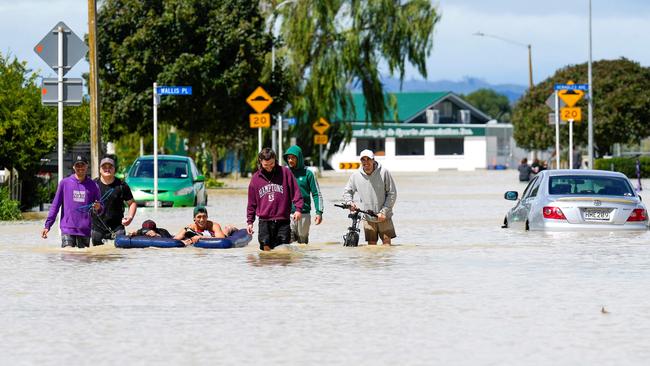 People wading through flood waters in the city of Napier, situated on the North Island's east coast. Picture: AFP