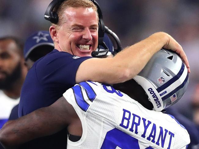 Head coach Jason Garrett of the Dallas Cowboys celebrates with Dez Bryant #88 after Bryant threw a touchdown pass against the Detroit Lions.