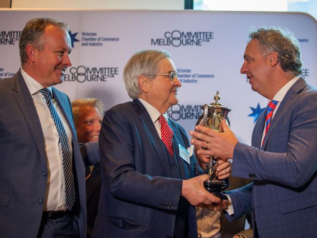 Gary Morgan (centre) presented a trophy to Scott Veenker (left) and Paul Guerra at the VCCI breakfast debate. Picture: Jessica Hooper