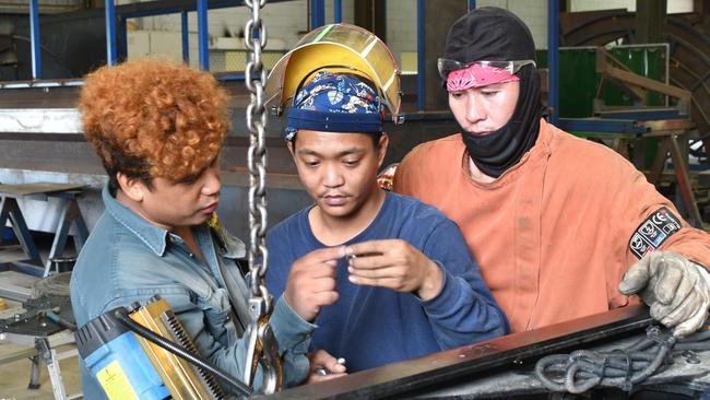 Carta &amp; Co fabrication supervisor and leading hand Glenford Merilos, a naturalised Australian, with migrant metal-processing workers Christian Castillo and Jan Vincent Pardinas. Picture: Cameron Bates