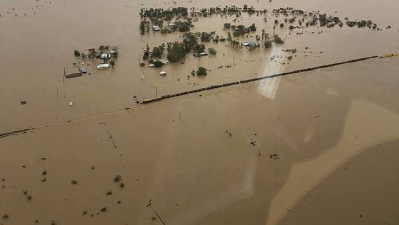 Floodwaters tip over 80-carriage train in outback Queensland