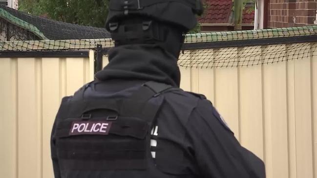 Police raid the home of Belal Betka, the first Australian-based person to be charged with foreign fighter links