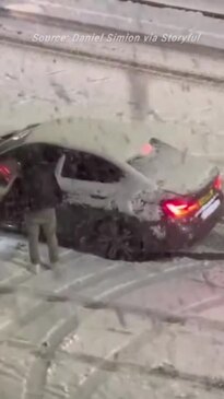 Cars struggle on snow-covered London roads