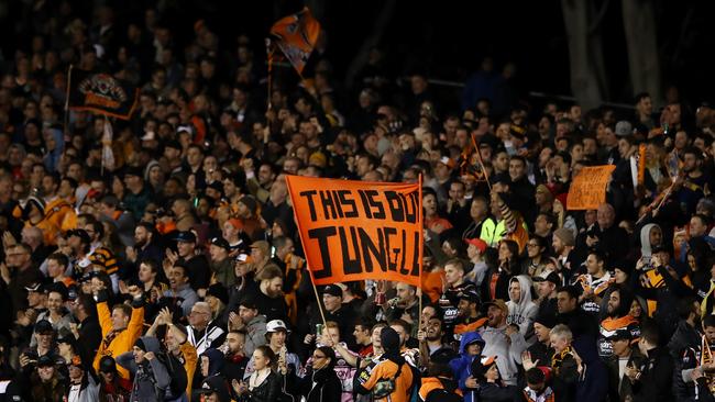 Wests Tigers fans celebrate a try during the Round 10 NRL match against the North Queensland Cowboys at Leichhardt Oval.