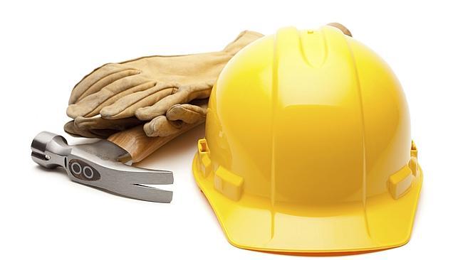 Yellow Hard Hat, Gloves and Hammer Isolated on White.