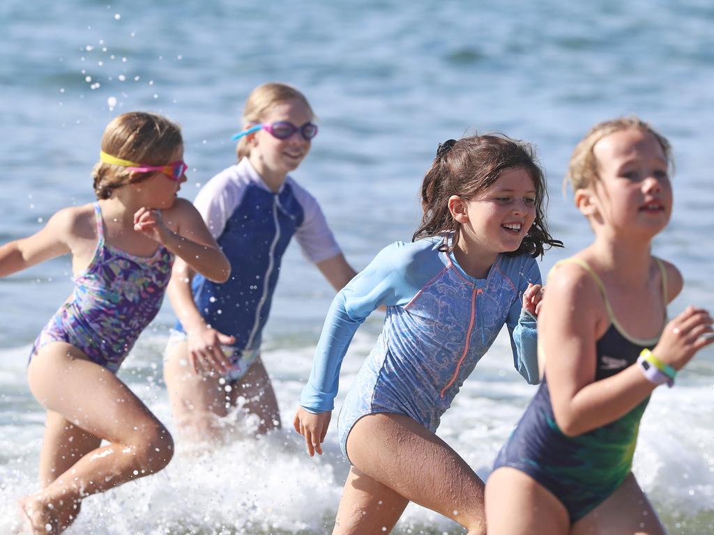 Participants in the 8 year old girls section finishing off their swim leg in the Bupa KidFit Series triathlon at Blackmans Bay Beach. Picture: LUKE BOWDEN