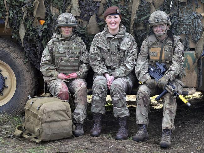 From left, Royal Army Medical Cops medic Corporal Vicky Helsby, 29, from Runcorn, Royal Wessex Yeomanry Tank Gunner reservist Lance Corporal Kat Dixon, 28, from Swindon and Royal Army Veterinary Corps Dog Handler Private Beth Johnson, 19, from Bridgwater during a Land Combat demonstration featuring women in command posts at Copehill Down Village on Salisbury Plain, Wiltshire. Women can now serve in all roles in Britainâ€™s military, including front-line combat units and the special forces. Defense Secretary Gavin Williamson announced the change Thursday, saying "the idea that we are excluding half the population from some of these most vital roles potentially holds our armed forces back." (Ben Birchall/PA via AP)