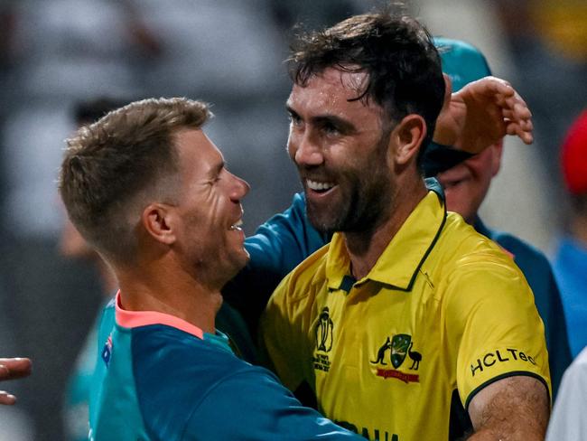 Australia's Glenn Maxwell (R) celebrates with David Warner after his epic knock against Afghanistan. Picture: AFP