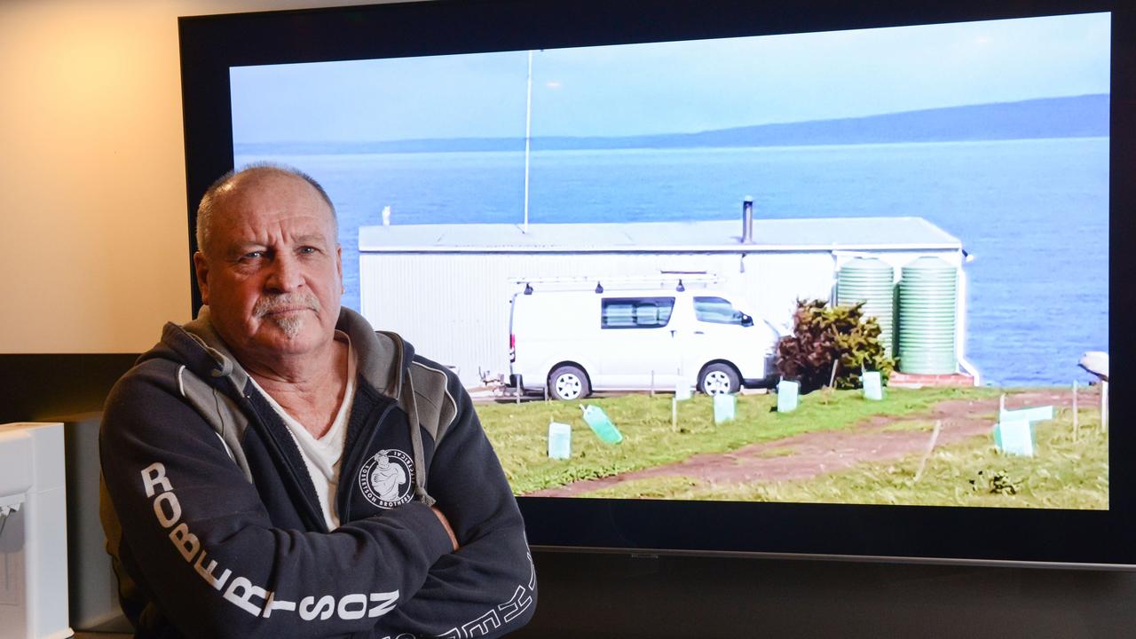 Mr Robertson with a picture of his shack in Deep Creek. Picture: Brenton Edwards
