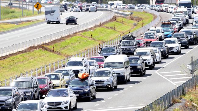 Driverless cars and smart city infrastructure should ease traffic gridlock like this seen on the Bruce Highway, but it requires significant investment to get it off the ground. Photo AAP/ Ric Frearson