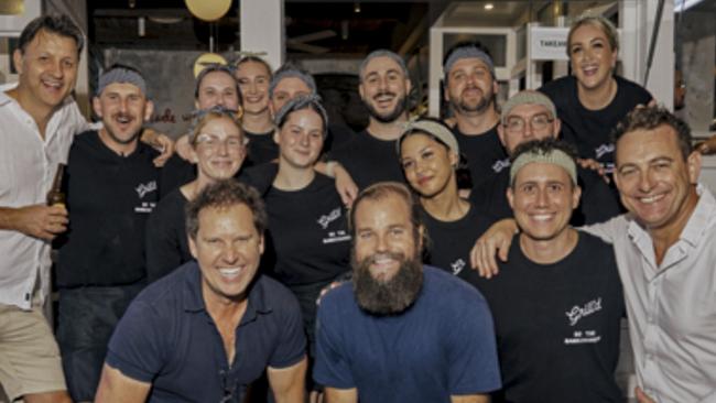 Grill'd CEO Simon Crowe and Sea Forest CEO Sam Elsom (bottom front) with the Byron Restaurant Crew at Grill'd, Byron's newest burger joint.