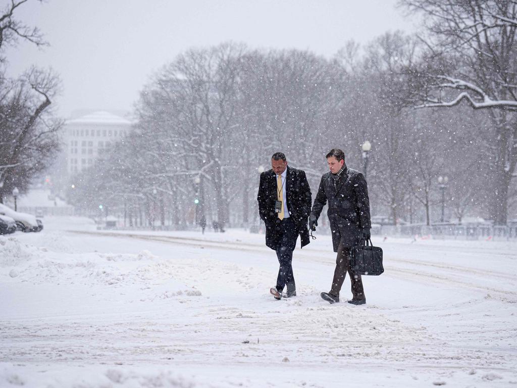 Workers walk through a winter storm as they arrive on Capitol Hill in the nation's capital on January 6, 2025 in Washington, DC. Congress is scheduled to certify the 2024 presidential elections result. Picture: Getty Images via AFP