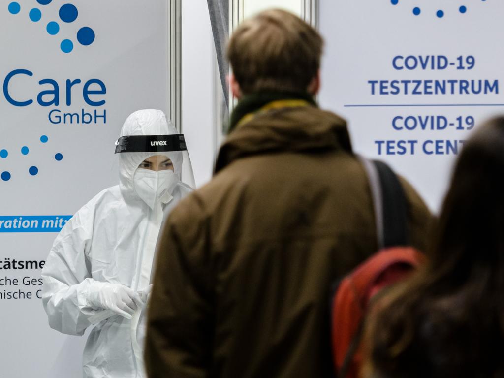 People wait in front of a coronavirus test centre in January in Leipzig, Germany as it is estimated half of Europe will contract the Omicron variant. Picture: Jens Schlueter/Getty Images