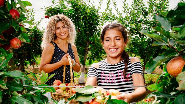 Sahara Daoud and her mum Vivian pick apples at Bilpin Fruit Bowl. Picture: Jonathan Ng