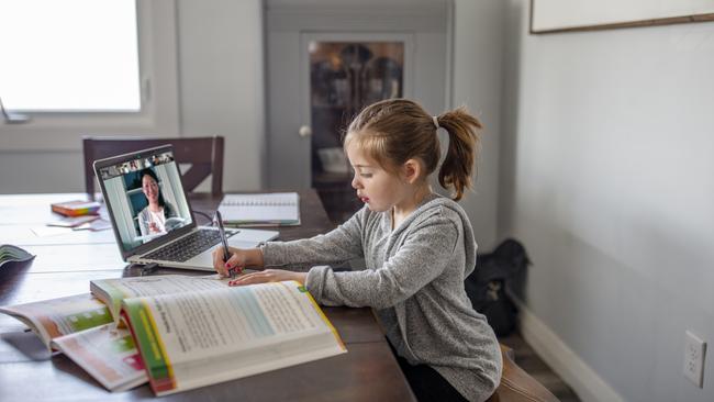 Stock image of a young girl studying at home during the Covid-19 pandemic.