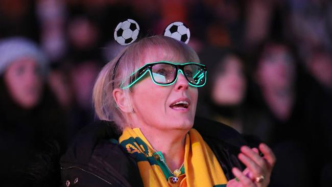 Fans At Sydney's FIFA Fan Site watch the Matildas FIFA World Cup game on Monday. It is too far to travel on Saturday night to make the kick off of the England game at Stadium Australia. (Photo by Roni Bintang/Getty Images)