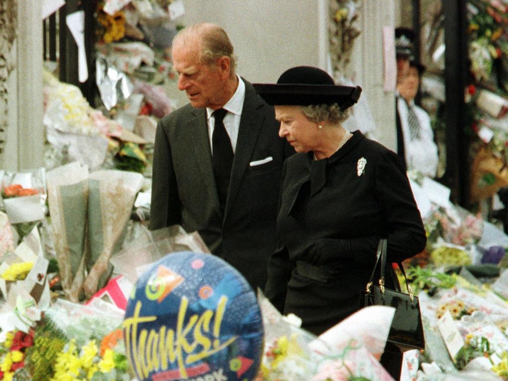 The monarch, right, and her husband inspected floral tributes to Diana outside London's Buckingham Palace. Picture: AP