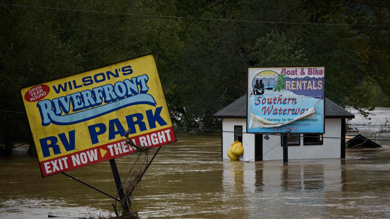 Signs for waterfront tourist parks sit under the heavy flood waters in Asheville. Picture: Melissa Sue Gerrits/Getty Images/AFP