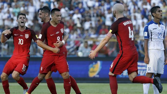 United States' Bobby Wood celebrates with teammates after scoring.