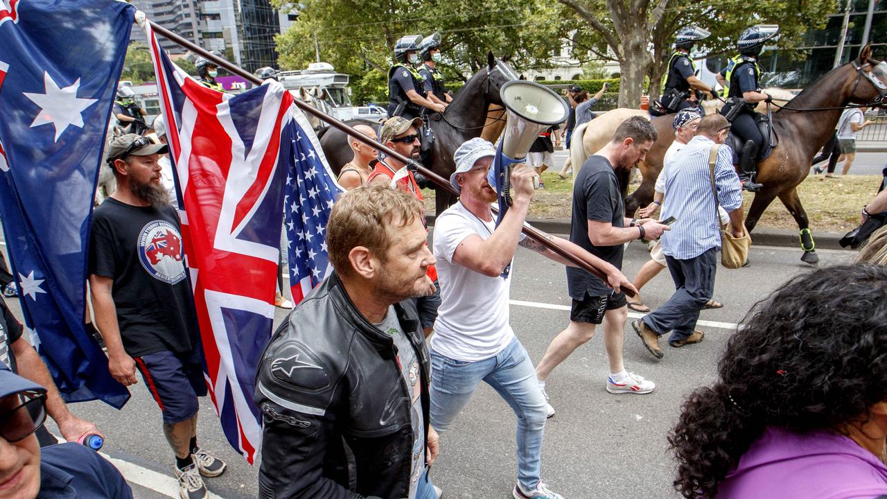 Protesters march past police at an anti-vaccination protest in St Kilda Road on Saturday afternoon. Picture: NCA NewsWire/David Geraghty