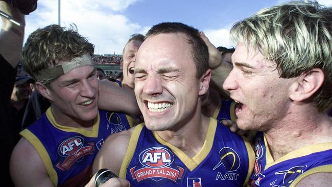 Luke Power celebrating with Shaun Hart and Jason Akermanis after winning the 2001 Grand Final.